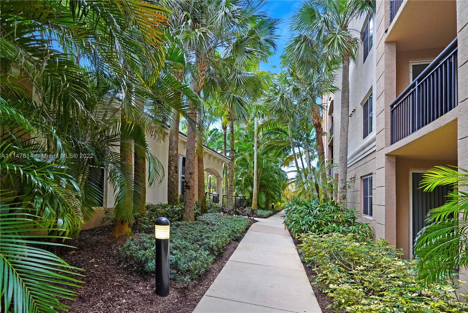 1660 Renaissance Commons Boulevard, Unit 2203 Boynton Beach, FL 33426 - Photo 16 of 20 a view of a pathway with house on both side