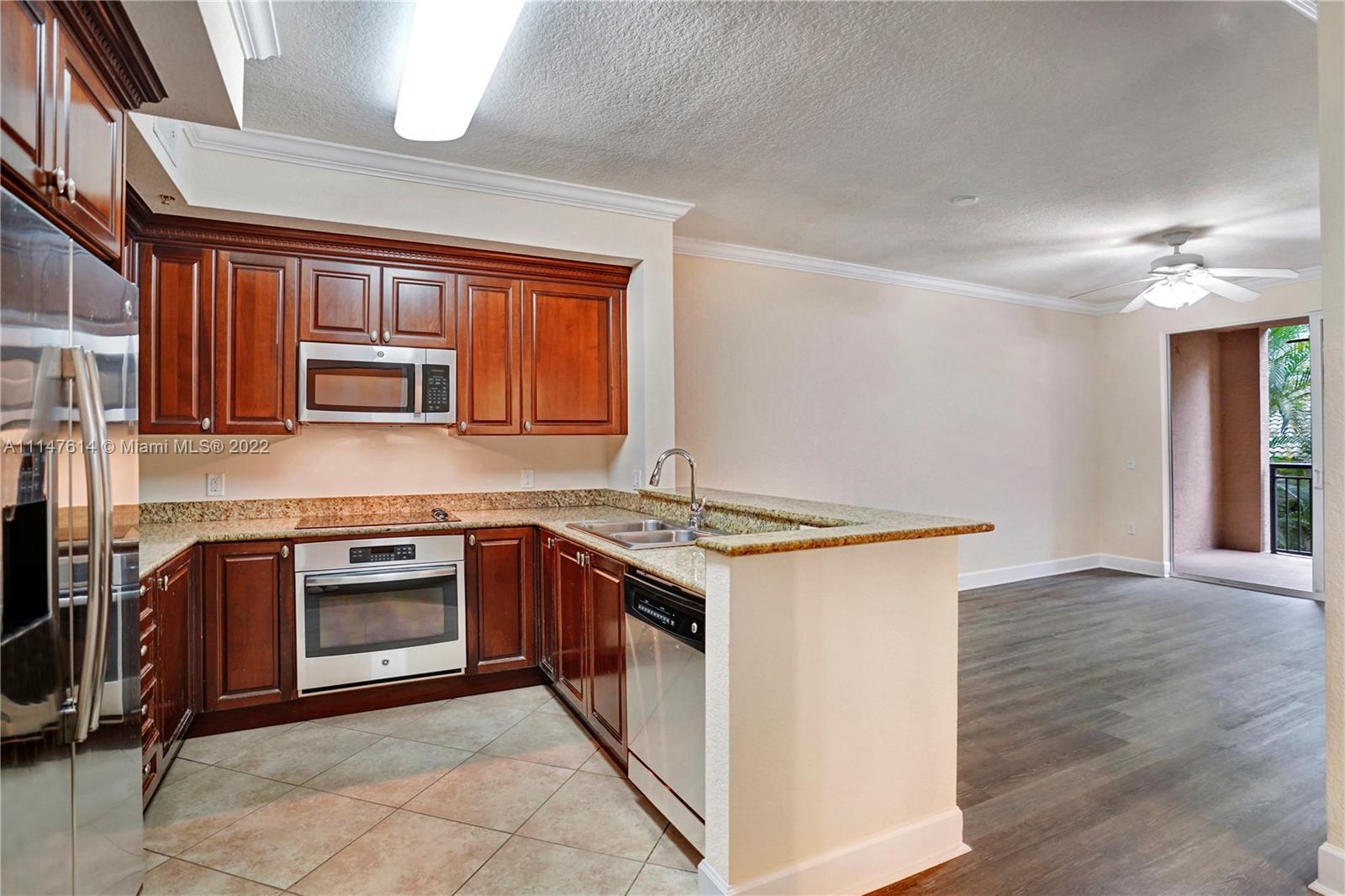 1660 Renaissance Commons Boulevard, Unit 2203 Boynton Beach, FL 33426 - Photo 2 of 20 a kitchen with stainless steel appliances granite countertop a stove and a sink