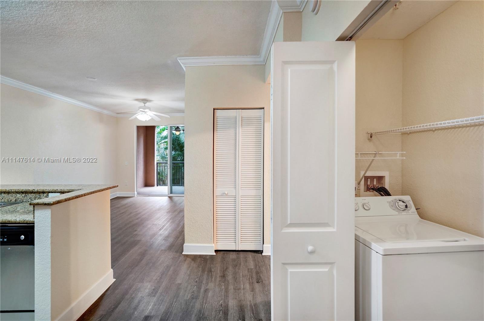 1660 Renaissance Commons Boulevard, Unit 2203 Boynton Beach, FL 33426 - Photo 4 of 20 a view of a kitchen with a stove wooden floor and a window
