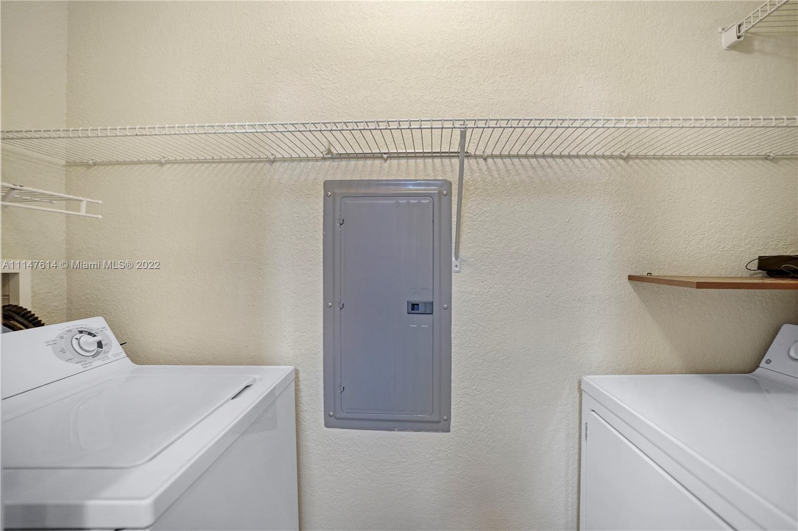 1660 Renaissance Commons Boulevard, Unit 2203 Boynton Beach, FL 33426 - Photo 6 of 20 a utility room with dryer and washer