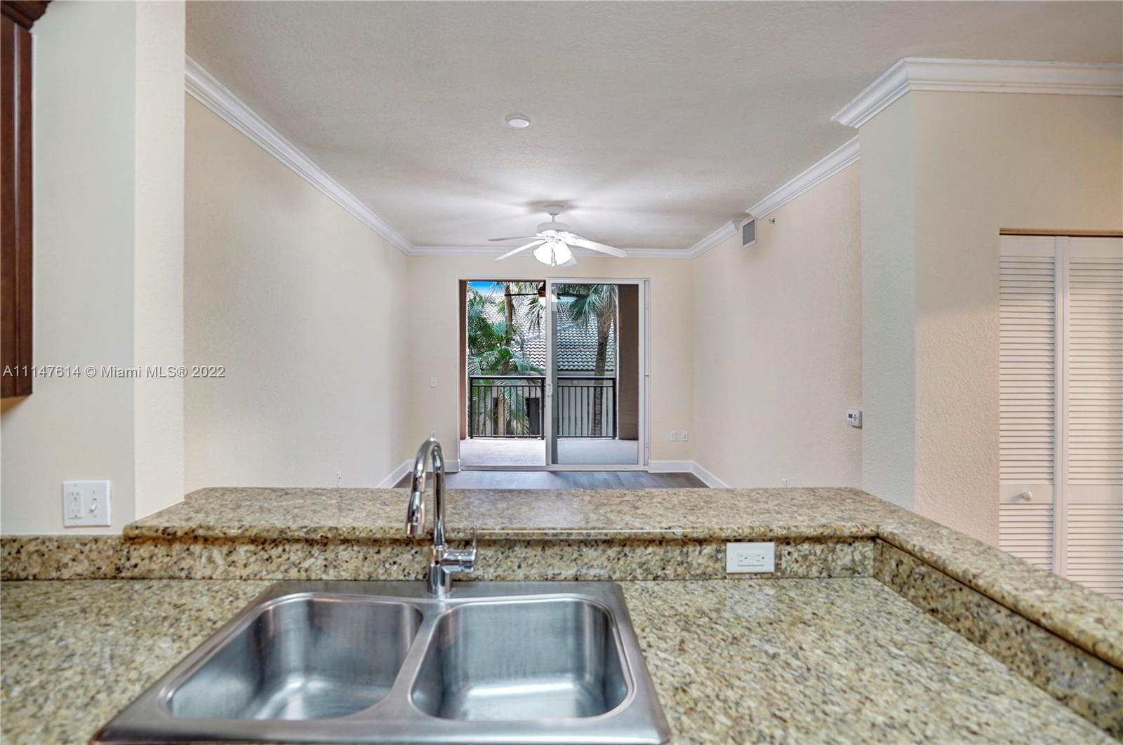 1660 Renaissance Commons Boulevard, Unit 2203 Boynton Beach, FL 33426 - Photo 7 of 20 a kitchen with a sink and granite counter top