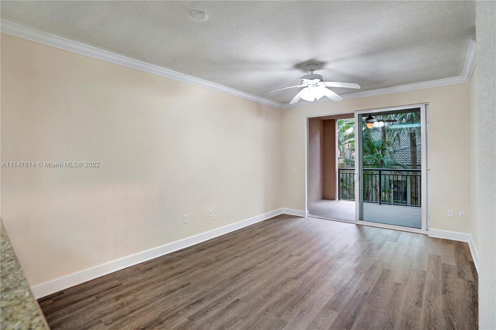 1660 Renaissance Commons Boulevard, Unit 2203 Boynton Beach, FL 33426 - Photo 8 of 20 a view of an empty room with wooden floor and a window