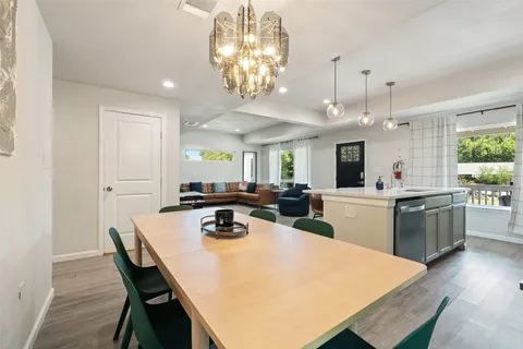 a large kitchen with a table and chairs