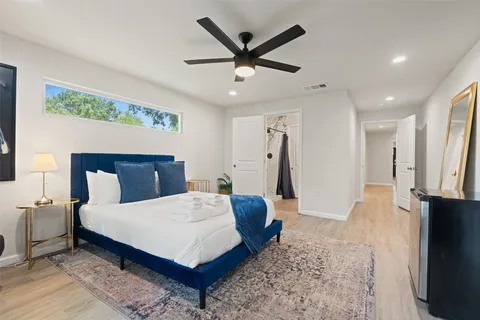 a living room with a bed furniture and a flat screen tv