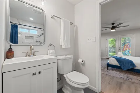 a bathroom with a toilet sink and mirror