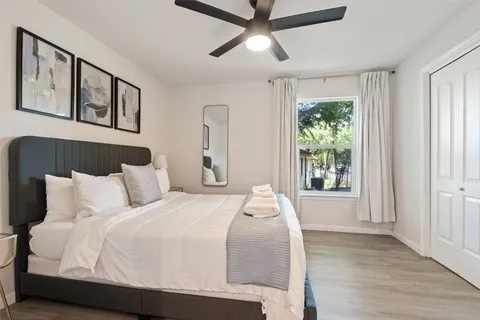 a bedroom with a large bed and a window