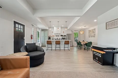 a living room with furniture and a large mirror