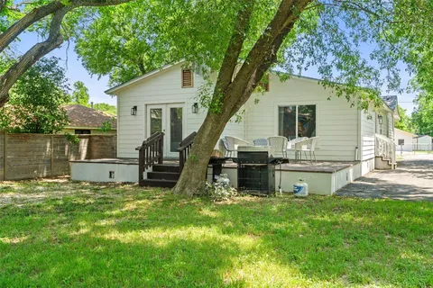 a backyard of a house with table and chairs