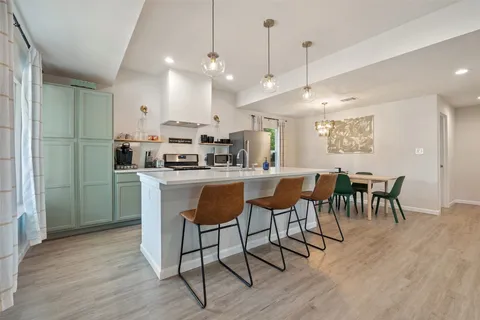 a large kitchen with a table and chairs