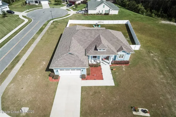 an aerial view of a house with swimming pool