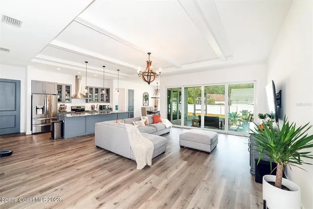 a living room with furniture and large windows