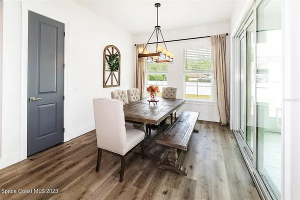 a view of a dining room with furniture window and wooden floor