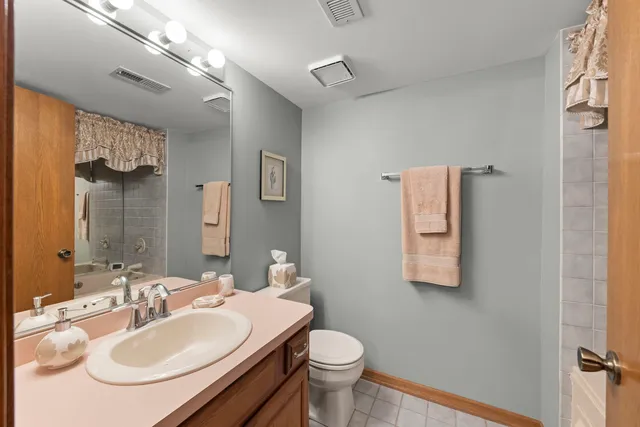 a bathroom with a sink toilet and a mirror