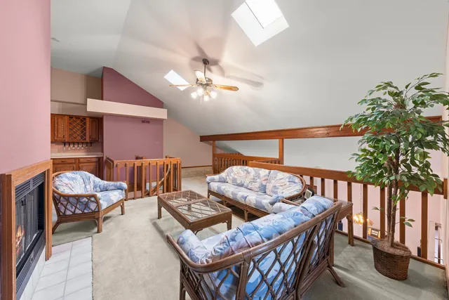 a living room with furniture a chandelier and a rug