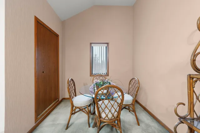 a view of a dining room with furniture and a window