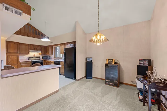 a kitchen with refrigerator and furniture