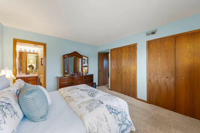 a bedroom with a large bed and bedroom view