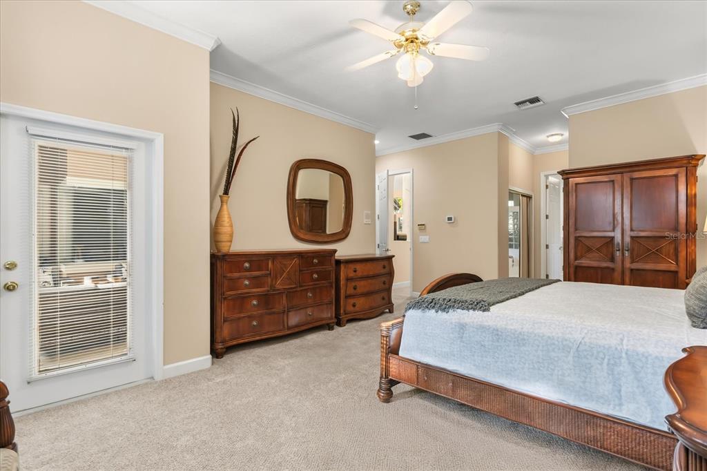 693 Stonefield Loop Lake Mary, FL 32746 - Photo 15 of 40 a bedroom with a bed a dresser and a chandelier