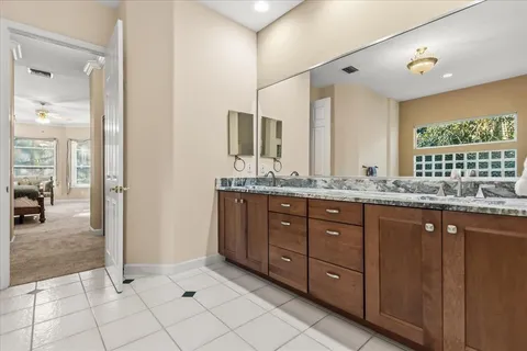 a bathroom with a granite countertop sink mirror and double