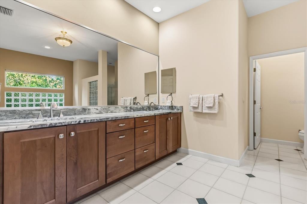 693 Stonefield Loop Lake Mary, FL 32746 - Photo 17 of 40 a bathroom with a granite countertop sink and a mirror