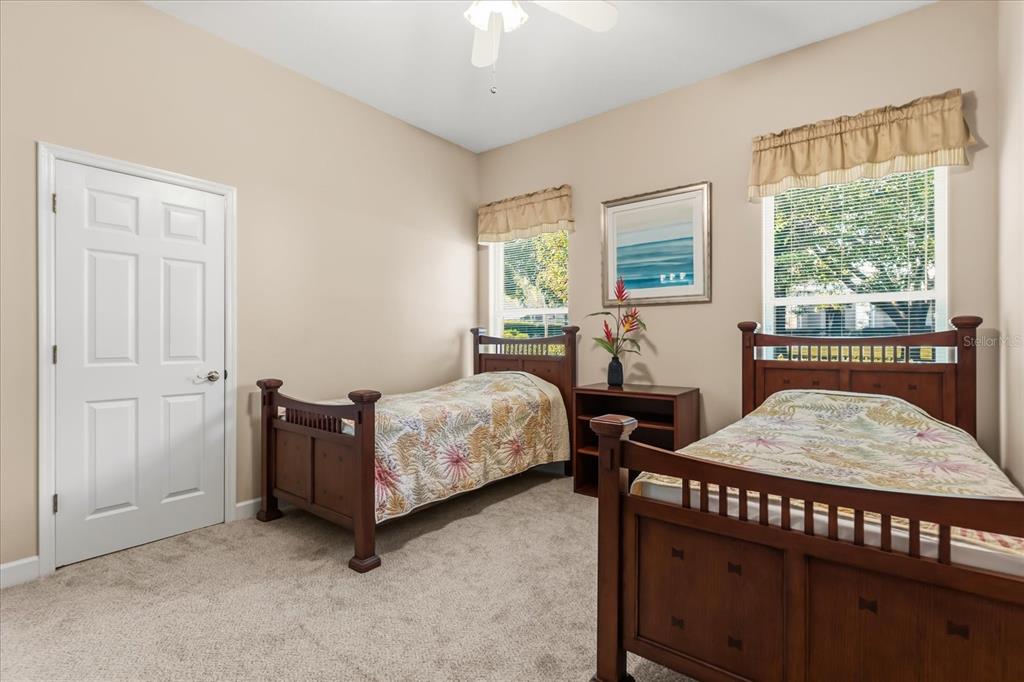 693 Stonefield Loop Lake Mary, FL 32746 - Photo 22 of 40 a bedroom with a bed and a table in it