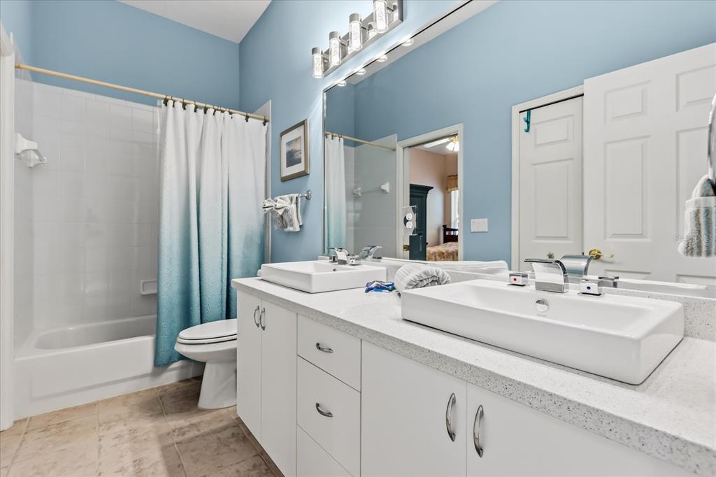 693 Stonefield Loop Lake Mary, FL 32746 - Photo 23 of 40 a bathroom with a double vanity sink mirror and toilet