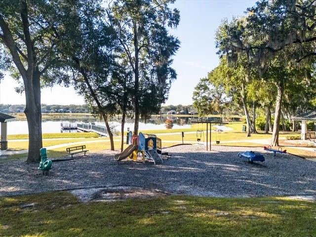 a view of a swimming pool with a patio and yard
