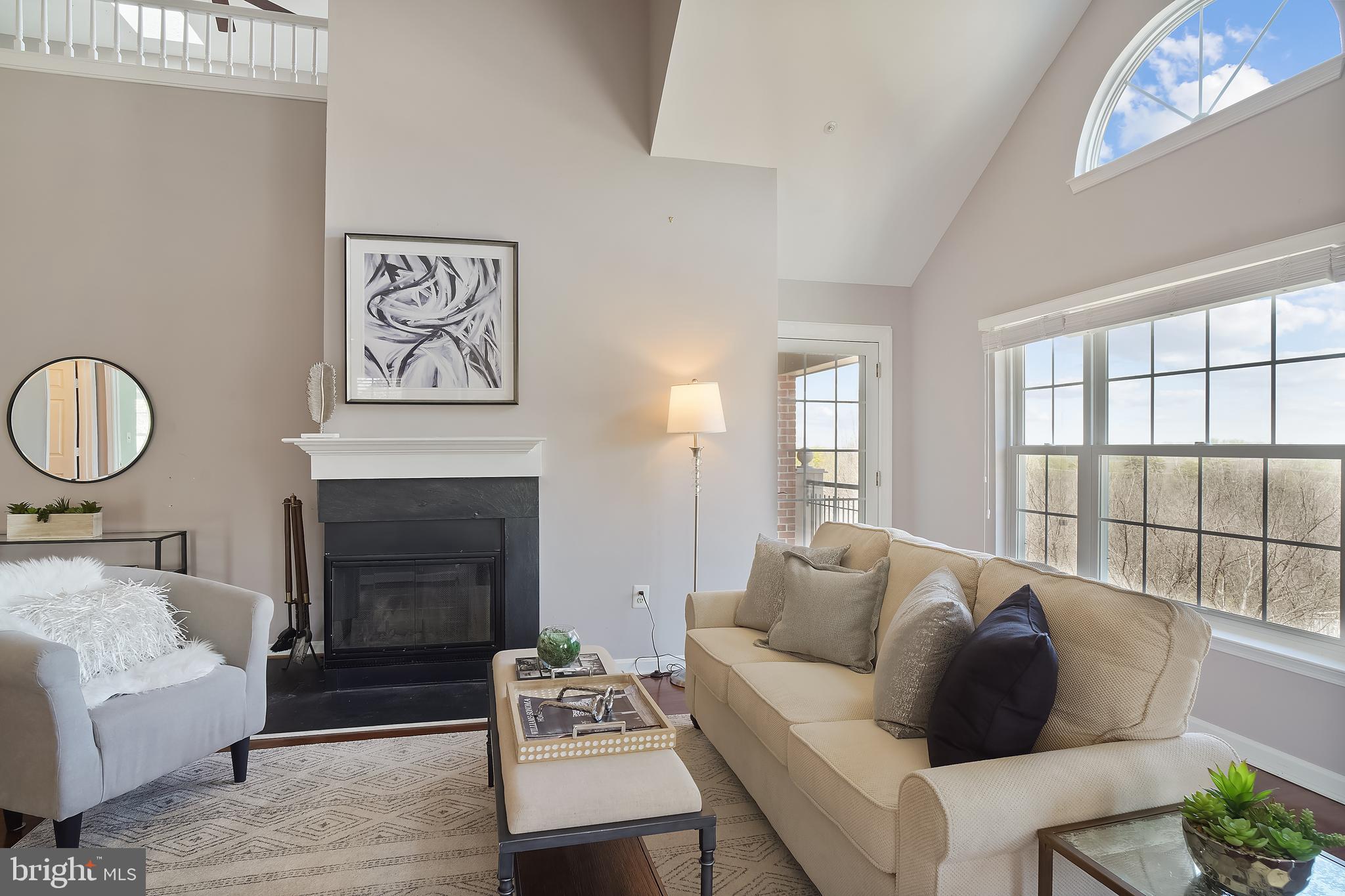 415 Ridgepoint Place, Unit 41534 Gaithersburg, MD 20878 - Photo 5 of 44 Large living room w/fireplace & access to balcony