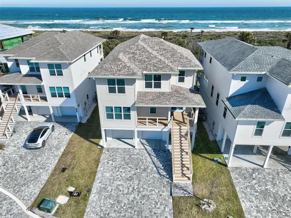 an aerial view of a house with garden space and sitting area