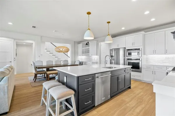 a kitchen with a sink appliances and cabinets