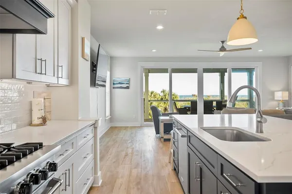a white stove top oven sitting inside of a kitchen