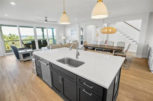 a kitchen with granite countertop white cabinets and stainless steel appliances