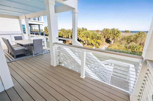 a view of a balcony with table and chairs