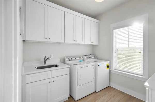 a view of a room with wooden floor and windows