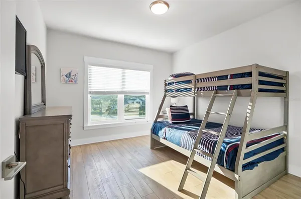 a bed sitting in a bedroom next to a window