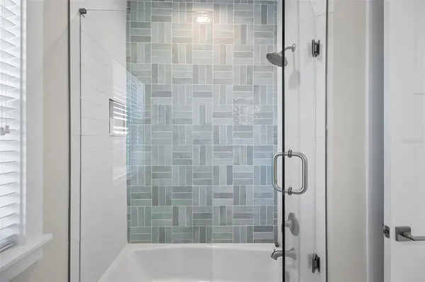 a spacious bedroom with a bed and a flat screen tv