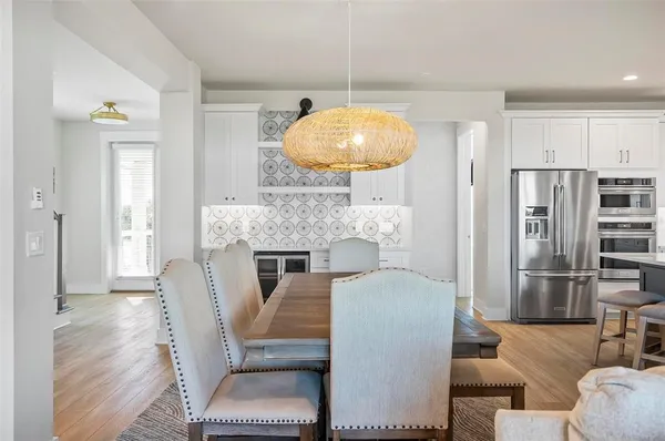 a kitchen with stainless steel appliances granite countertop a kitchen island a table and chairs in it