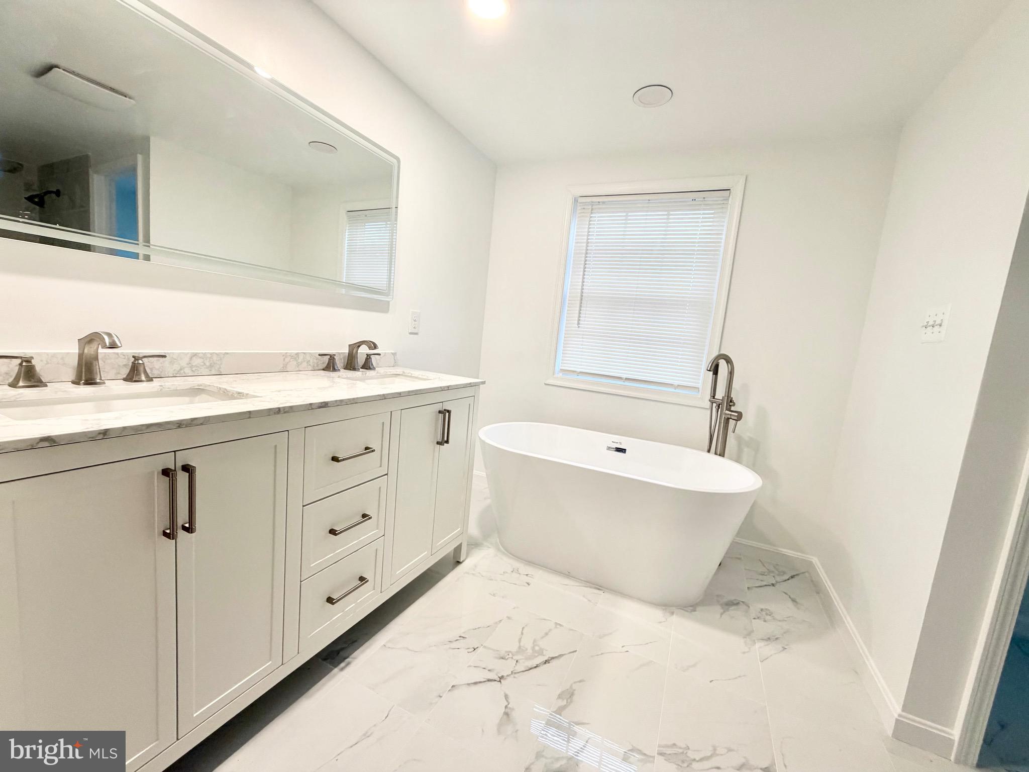 4001 Middle Ridge Drive Fairfax, VA 22033 - Photo 9 of 17 a bathroom with a granite countertop sink mirror vanity bathtub and toilet