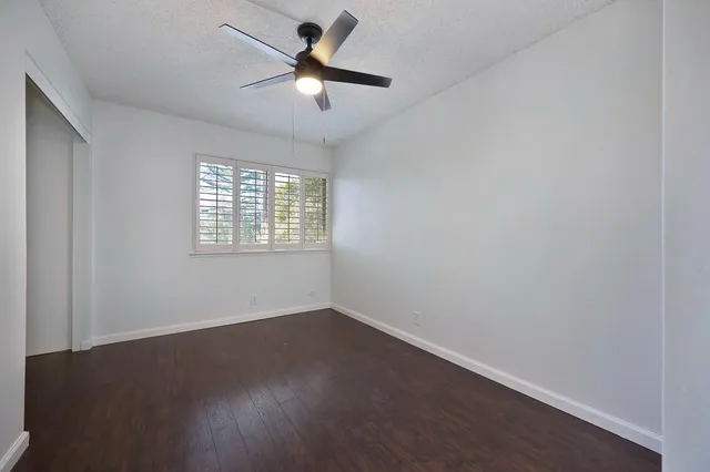 a bathroom with a toilet sink vanity tub and mirror