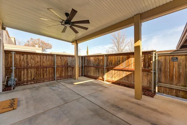 a view of a hallway with wooden fence
