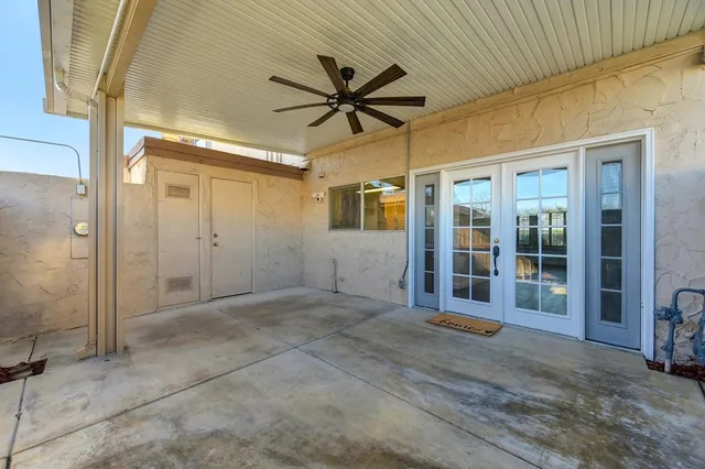 a view of a house with a wooden fence
