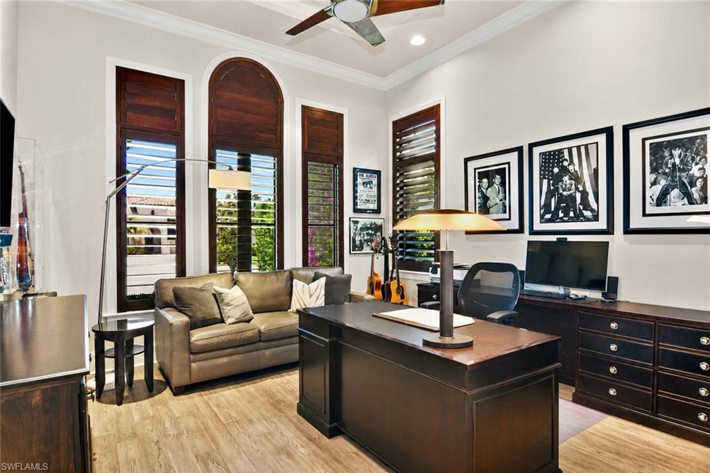 2220 Residence Circle Naples, FL 34105 - Photo 16 of 50 a living room with furniture and a fireplace