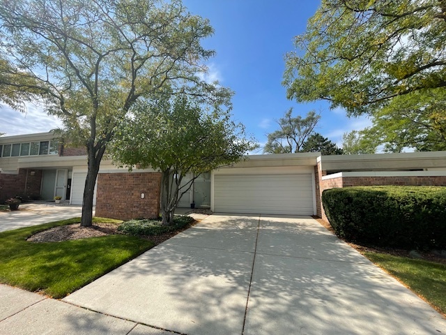 8 Avon Road Northbrook, IL 60062 - Photo 1 of 15 a front view of a house with a yard and garage