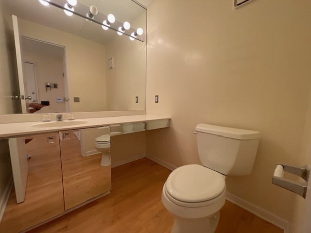 8 Avon Road Northbrook, IL 60062 - Photo 3 of 15 a bathroom with a sink a toilet a mirror and shower