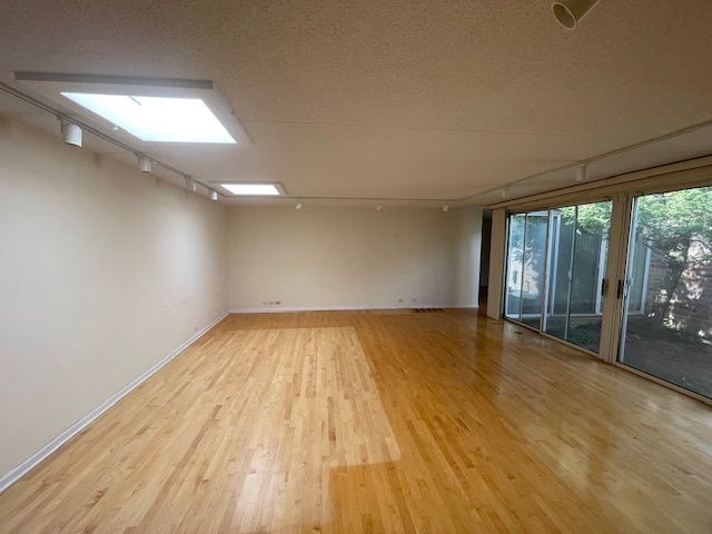 8 Avon Road Northbrook, IL 60062 - Photo 4 of 15 a view of empty room with wooden floor and fan
