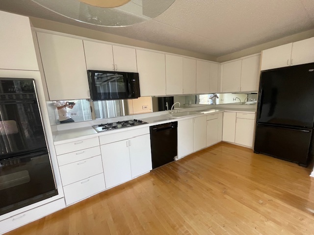 8 Avon Road Northbrook, IL 60062 - Photo 7 of 15 a kitchen with a sink a refrigerator a stove top oven a washer and dryer