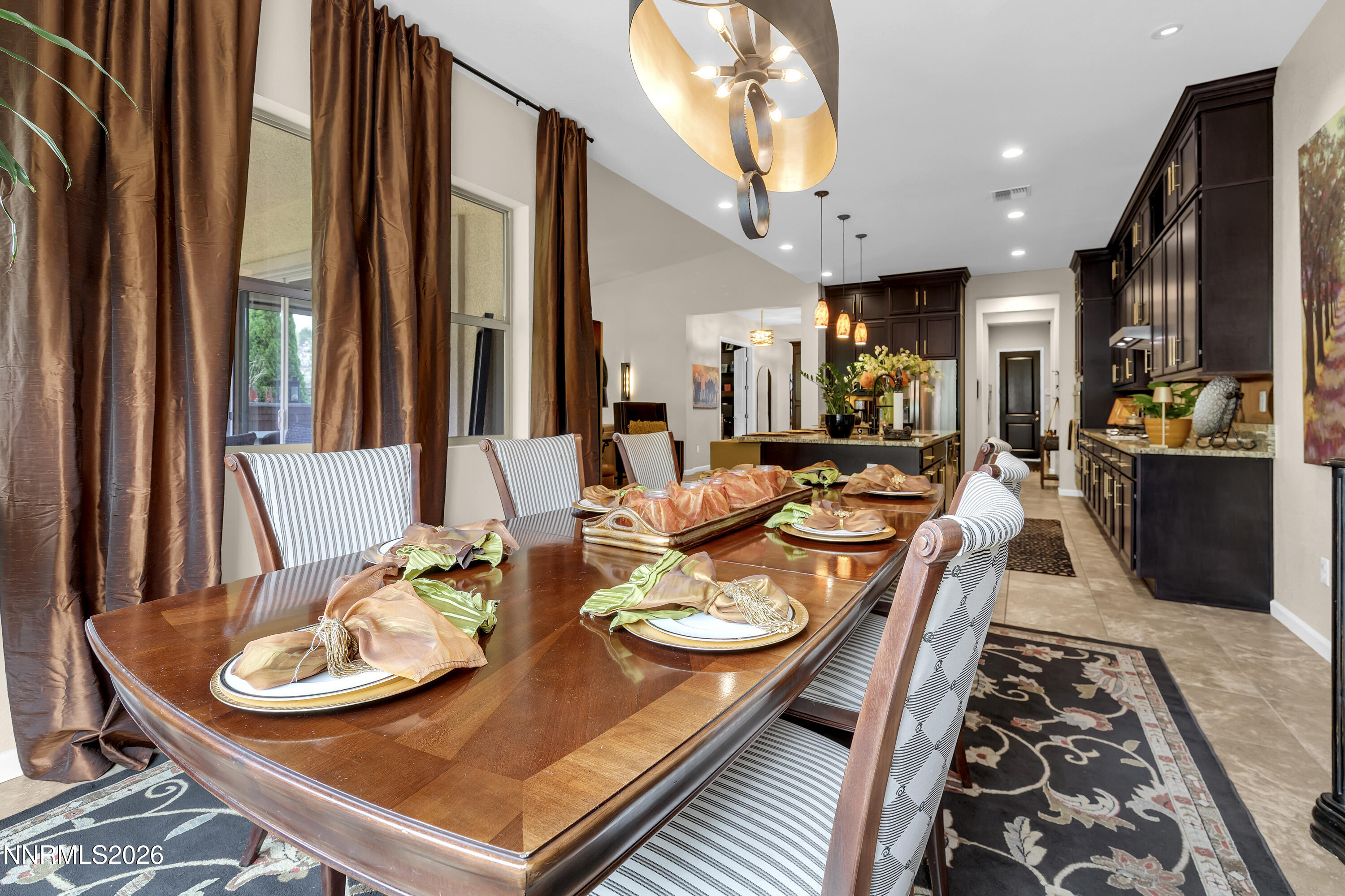 9021 Iron Sky Court Reno, NV 89523 - Photo 11 of 39 a dining room with furniture a large window and wooden floor