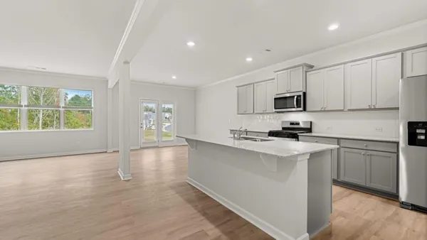 a kitchen with granite countertop white cabinets and white appliances