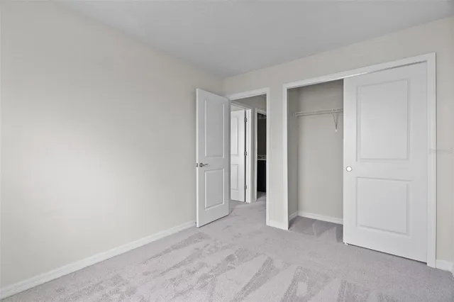 a view of an empty room and closet area