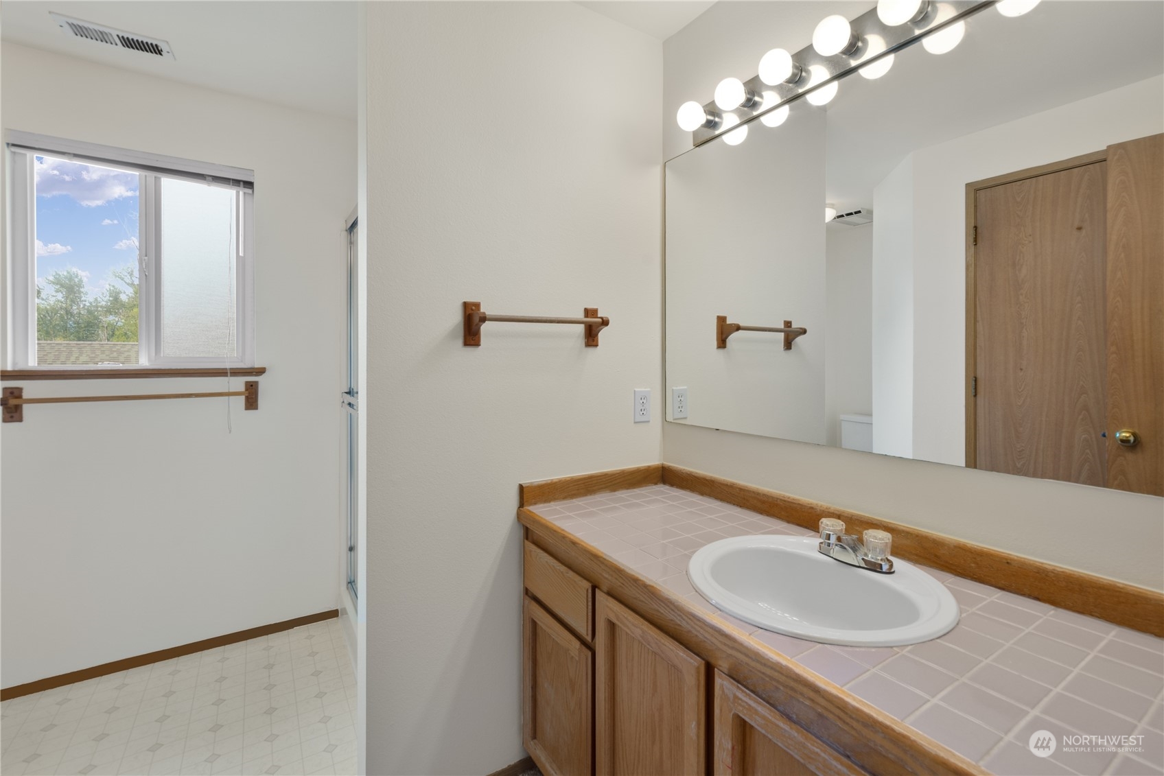 2313 211th Street Southeast Bothell, WA 98021 - Photo 14 of 25 a bathroom with a sink and a mirror